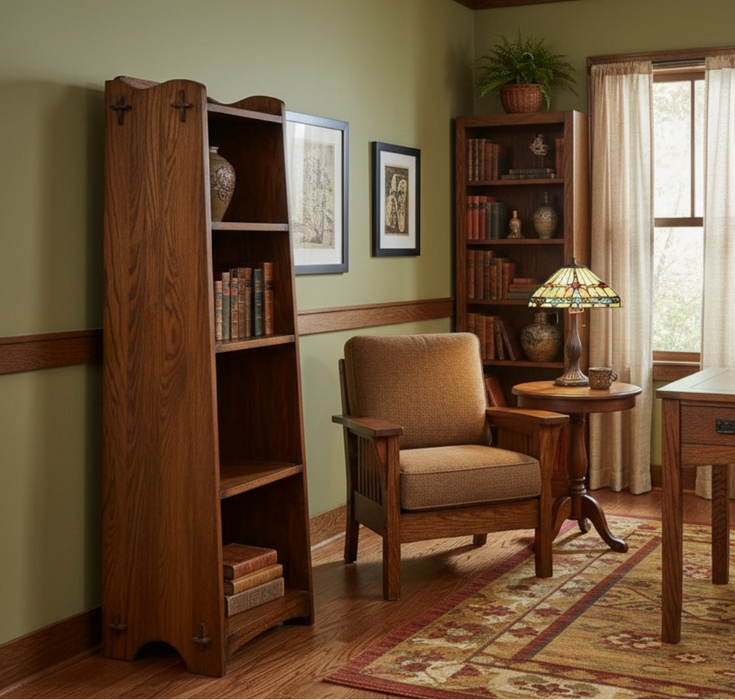 Wooden bookshelf and chair in a room with a lamp and framed pictures.