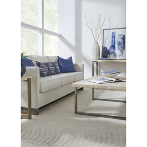 Ariela coffee table made of natural travertine with a bronze-colored metal base
