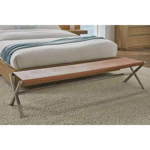 A modern dining bench made of leather in a coastal director style, in cognac and brushed stainless steel.