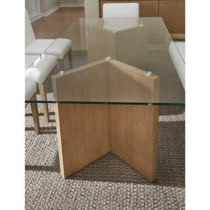 A modern coastal-style dining table with a glass top made of white oak.