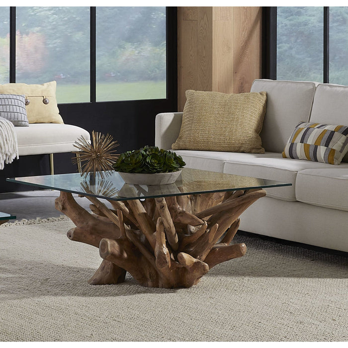 A coffee table made of solid teak wood with a glass top.